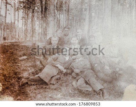 POLAND, CIRCA FORTIES - Vintage portrait of group of men resting in forest