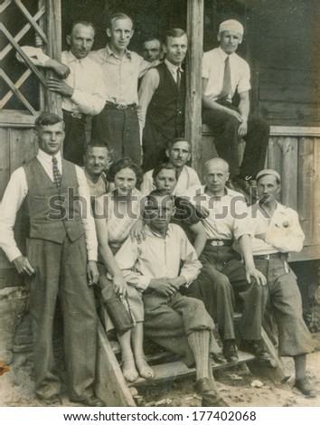 POLAND, CIRCA FORTIES - Vintage photo of group of people on stairs in front of house