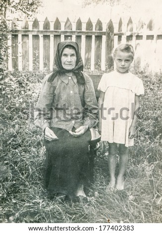 KOSTOPIL,UKRAINE, CIRCA 1955 - Vintage photo of grandmother with granddaughter