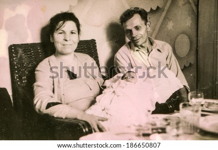 LODZ, POLAND, CIRCA 1950\'s: Vintage photo of parents with a baby