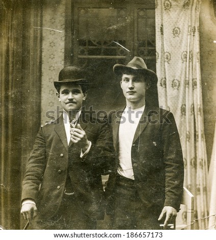 LODZ, POLAND, CIRCA 1950\'s: Vintage photo of two men in hats smoking cigarettes