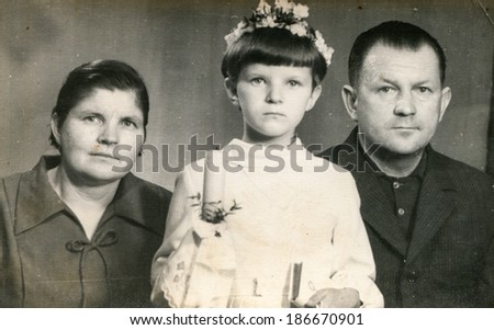 LODZ, POLAND, CIRCA 1950\'s: Vintage photo of girl with parents at her First Communion