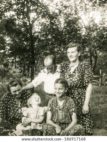LODZ, POLAND, CIRCA 1950\'s: Vintage photo of grandmother and parents with children in garden