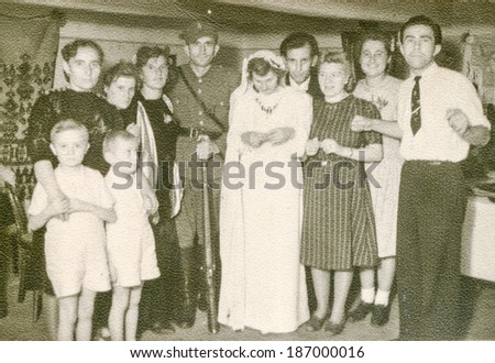 LODZ, POLAND, CIRCA 1950\'s: Vintage photo of newlyweds with family and guests