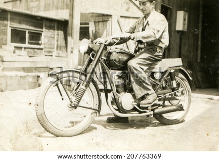 SIERADZ, POLAND, CIRCA FIFTIES - Vintage portrait of man on motorcycle
