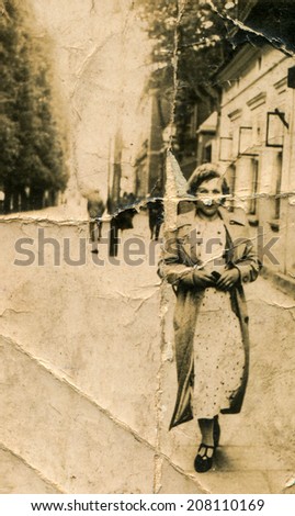 SIERADZ, POLAND, CIRCA SIXTIES - Vintage portrait of woman walking down the street