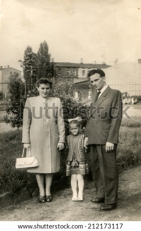 SIERADZ, POLAND, CIRCA FIFTIES - Vintage photo of parents with their daughter