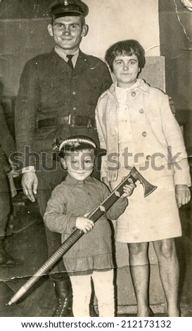 SIERADZ, POLAND, CIRCA FIFTIES - Vintage photo of parents with their little son