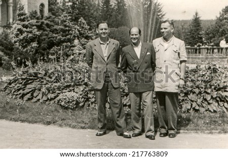 LODZ, POLAND, CIRCA FIFTIES - Vintage photo of three men in park