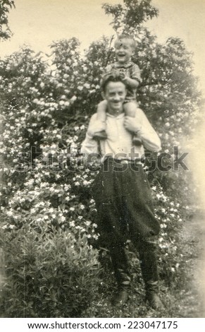ZBICZNO, POLAND, CIRCA JUNE 1946 - Vintage photo of father with little son