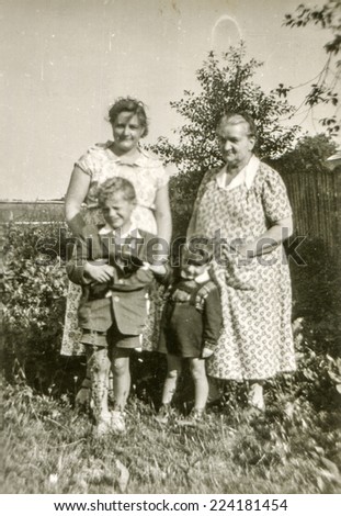 LODZ, POLAND, CIRCA FIFTIES: Vintage photo of grandmother and mother with sons