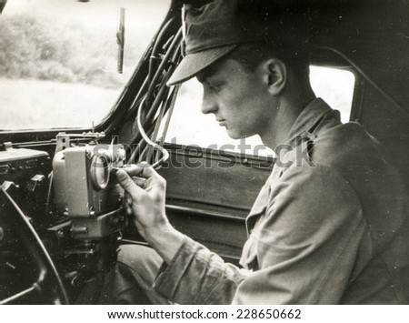 SOCZEWKA, POLAND, CIRCA SIXTIES: Young soldier exercises  in car during a military training