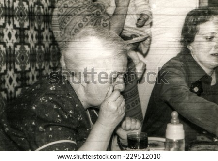 Vintage photo of child anniversary - mother and grandmother at table, 1982