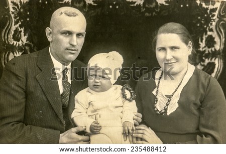 GERMANY, CIRCA 1930s: Vintage photo of parents with their child