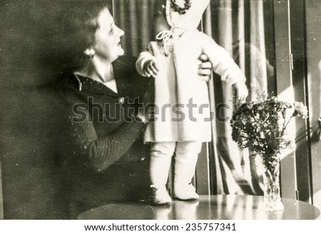 GERMANY, OCTOBER 11, 1938: Vintage photo of mother with her little daughter