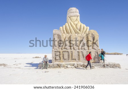 SALAR DE UYUNI, BOLIVIA, MAY 15, 2014: Tourists visit The Dakar Bolivia Monument made from salt bricks