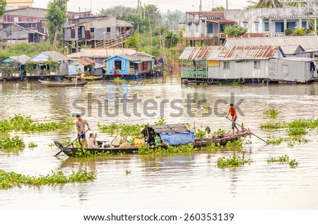 CHAU DOC, VIETNAM - JANUARY 2, 2013:  Local fishermen go back to the port on Hau River (Bassac River) in Chau Doc in Mekong Delta