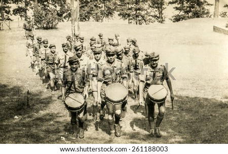 SZCZAWNICA, POLAND, CIRCA 1950\'s: Vintage photo of group of scouts marching outdoor and playing drums