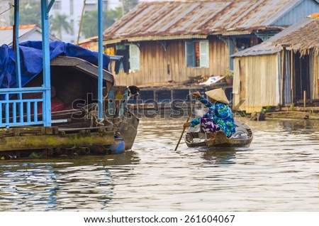 CHAU DOC, VIETNAM, JANUARY 3, 2013: Local woman on boat in floating village on Hau River (Bassac River) in Chau Doc in Mekong Delta