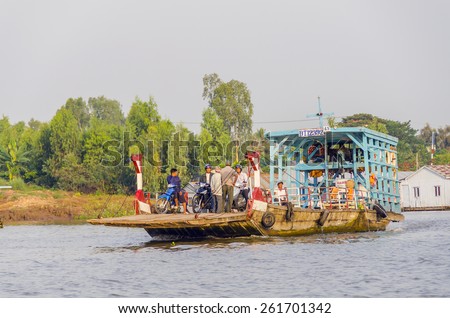 CHAU DOC, VIETNAM, JANUARY 3, 2013:Local people travel on a ferry on Hau River (Bassac River) in Chau Doc in Mekong Delta