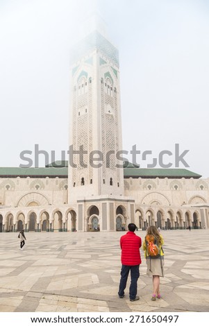 Tourists visiting Hassan II Mosque or Grande Mosquee Hassan II in Casablanca, Morocco, by misty morning