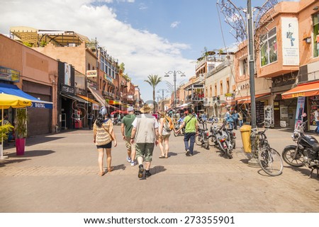 MARRAKESH, MOROCCO, APRIL 3, 2015: Tourists walk on Bab Agnaou street in direction of Jemaa el-Fnaa square
