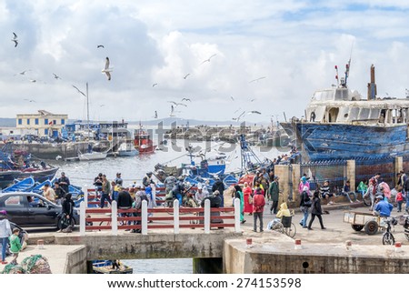 AS-SAWIRA, MOROCCO, APRIL 7, 2015: Local people and tourists walk in fishing port of As-Sawira