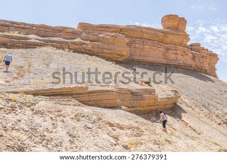 Tafilalt oasis in Morocco - young tourists visit rock formations