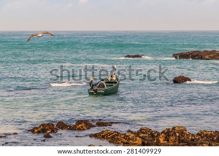 OUALIDIA, MOROCCO, APRIL 6, 2015: Fishermen go to sea in fishing boat