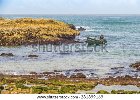 OUALIDIA, MOROCCO, APRIL 6, 2015: Fishermen come back from sea in fishing boat