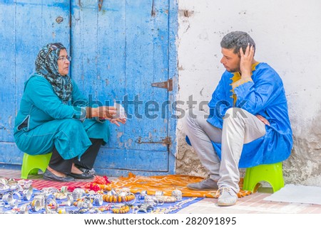 AS-SAWIRA, MOROCCO, APRIL 7, 2015: street sellers of local jewelry chat waiting for buyers