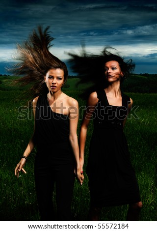 Portrait beautiful girls with great fly-away hair on a background of a landscape