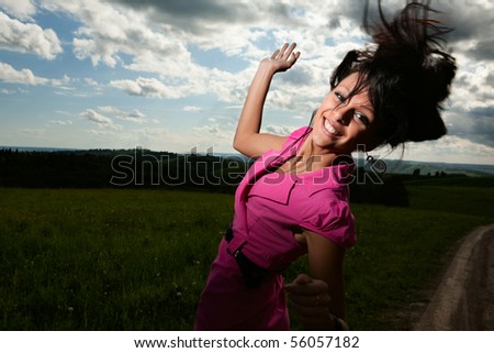 Portrait beautiful girl with great fly-away hair on a background of a landscape