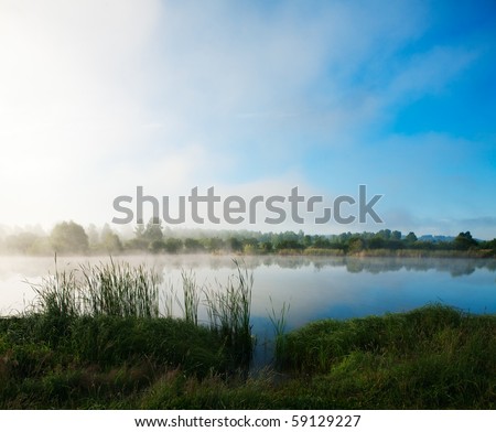 Landscape with lake and a morning fog