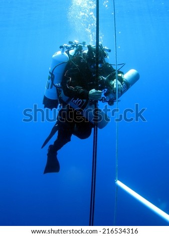 DAHAB, EGYPT - June 27, 1014: Ahmed Gabr descending on a line during his 220 m training dive prior to his deepest scuba dive world record attempt in September 2014