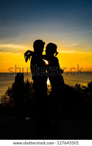 Couple love on the top of view with sunrise silhouette style