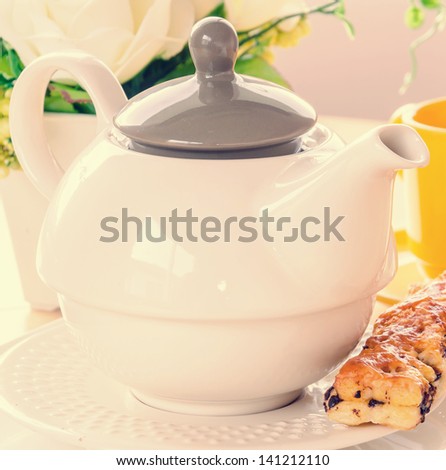 Tea pot on the wood table (Process in vintage style picture)