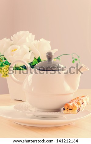 Tea pot on the wood table (Process in vintage style picture)
