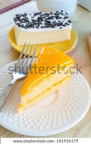 Orange cake in white dish on the wood table