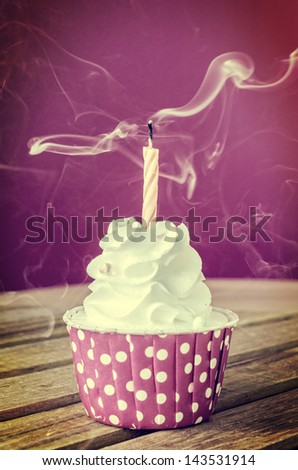 White cream cupcake with candle (Procress effect vintage style on this photo)