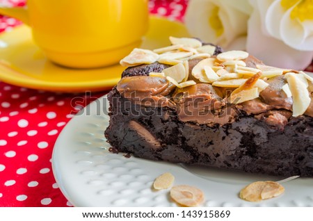 Brownie cake on white dish with almond&chocolate chip