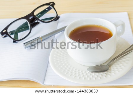 Paper note with eye glasses&white cuptea