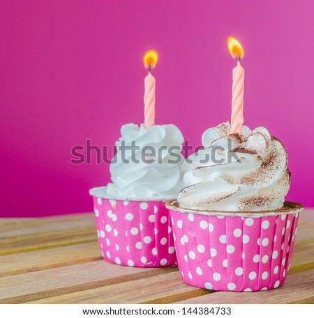 White cream cupcake with candle