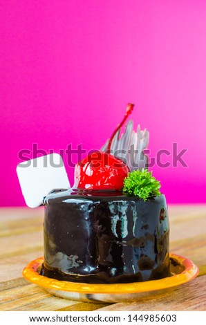 Chocolate cake with cherry on top color background