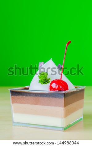 Vanilla , Chocolate , Coffee layer cake with cherry on top&colorful background