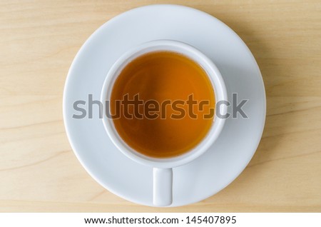 white tea cup on the wood table (Bird eye view)