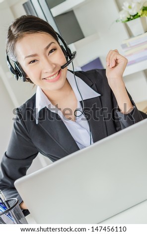 Business women happy with laptop in office