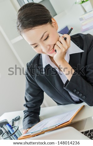 Business women thinking in office