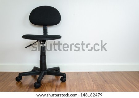 Office chair with white wallpaper