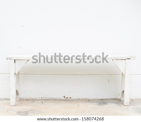 White bench on the white concrete wall